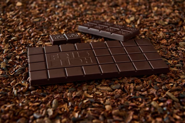 Dark chocolate bars on cacao nibs