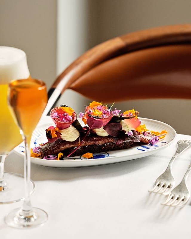 Herring smørrebrød with flowers, beer and snaps
