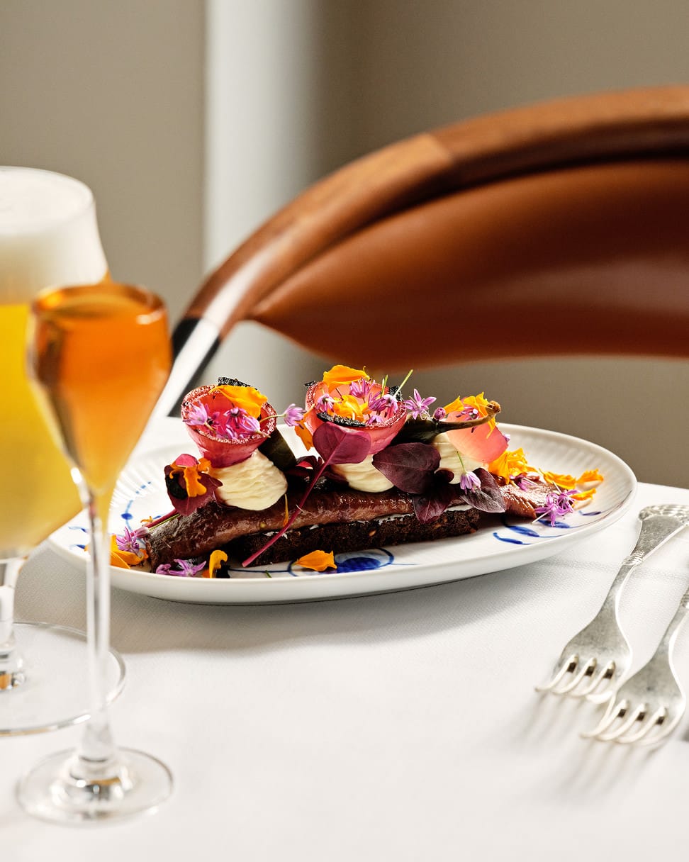 Herring smørrebrød with flowers, beer and snaps