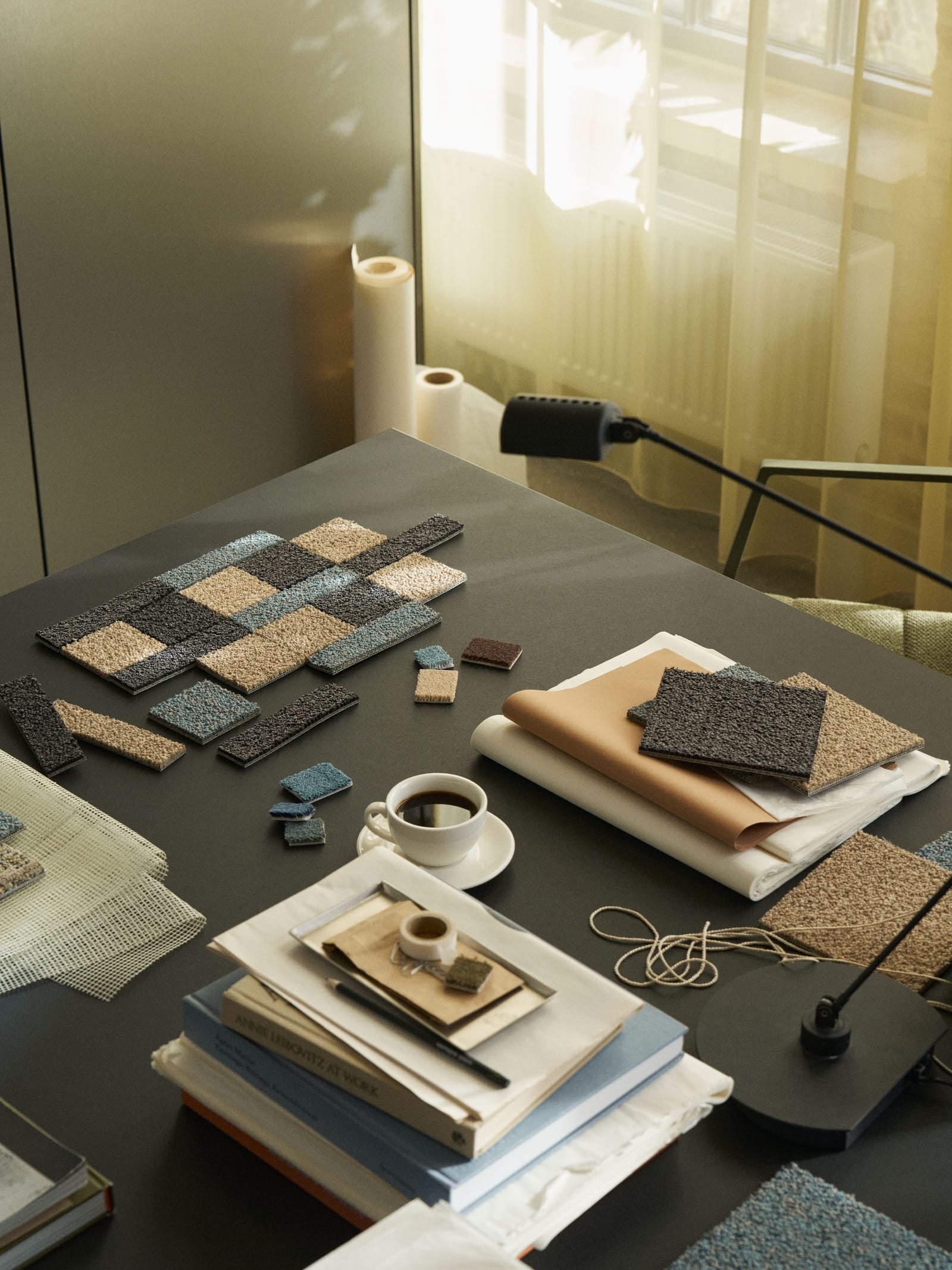 Carpet tile and plank samples on a design desk