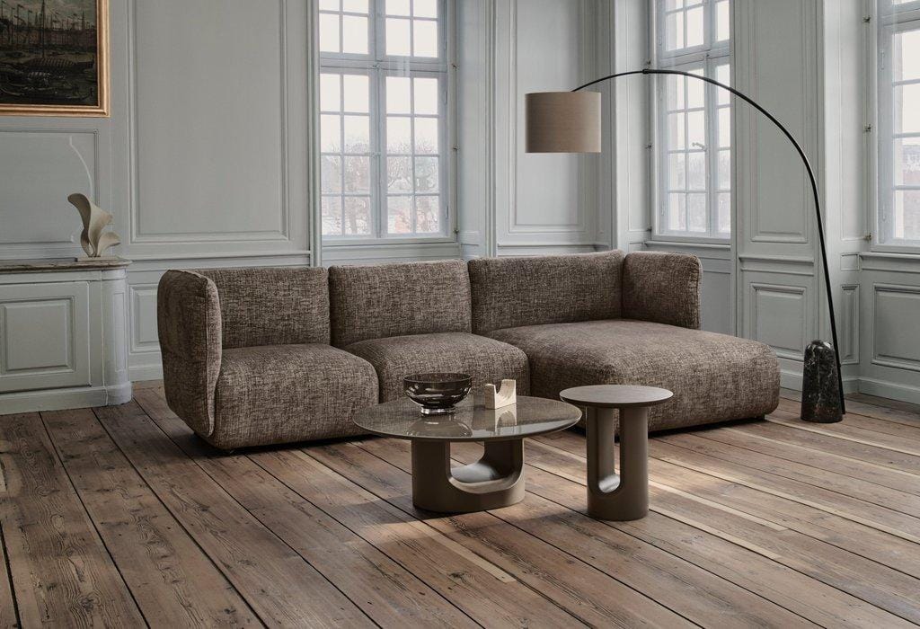 Paraggi sofa in a panelled room with coffee tables