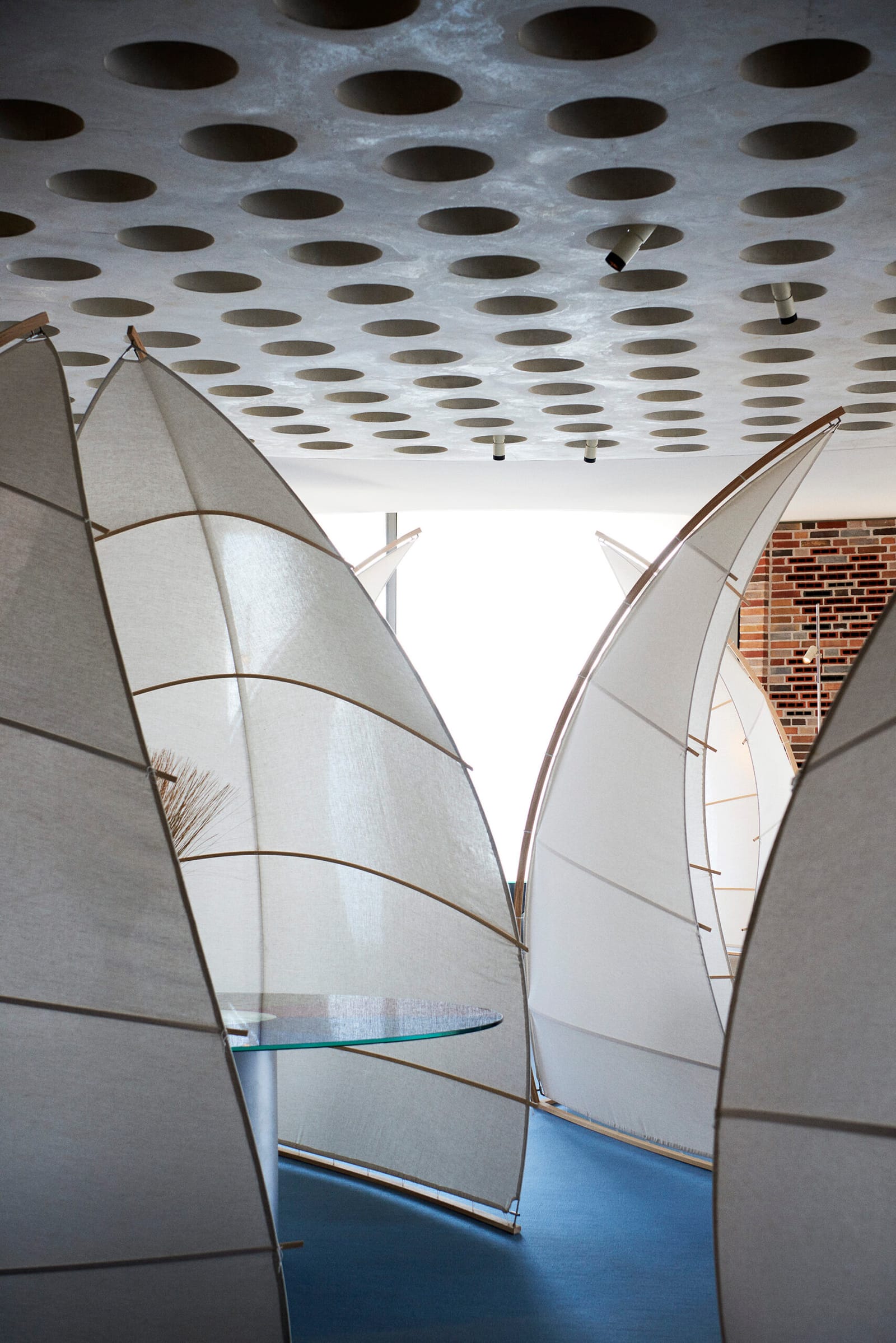 Linen screens around a table inside Fjordenhus
