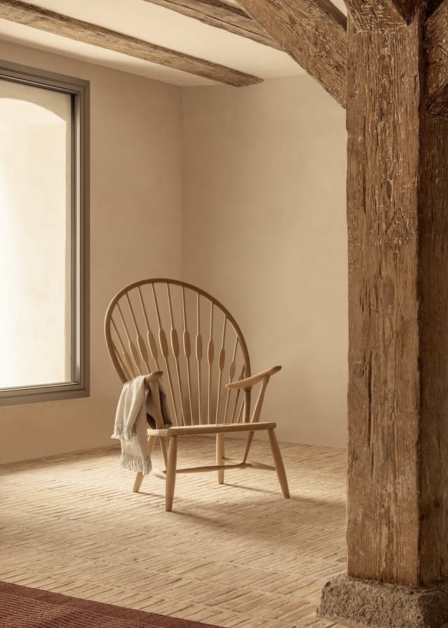 The Peacock Chair in a room with timber beams