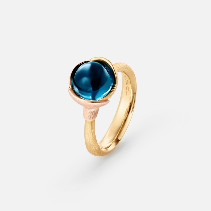 A Lotus ring in gold with a blue topaz cabochon