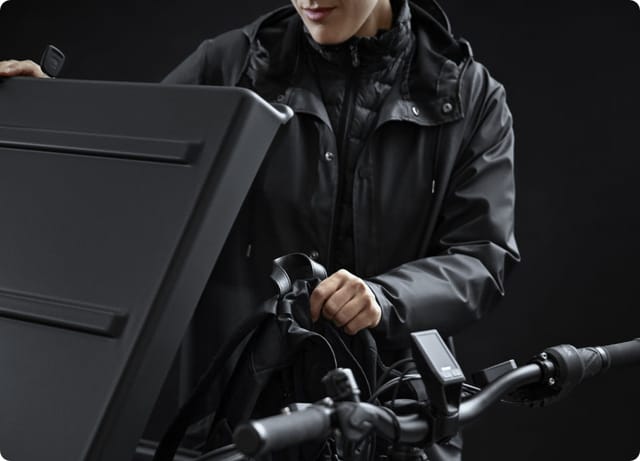 Taking a bag from the open cargo box