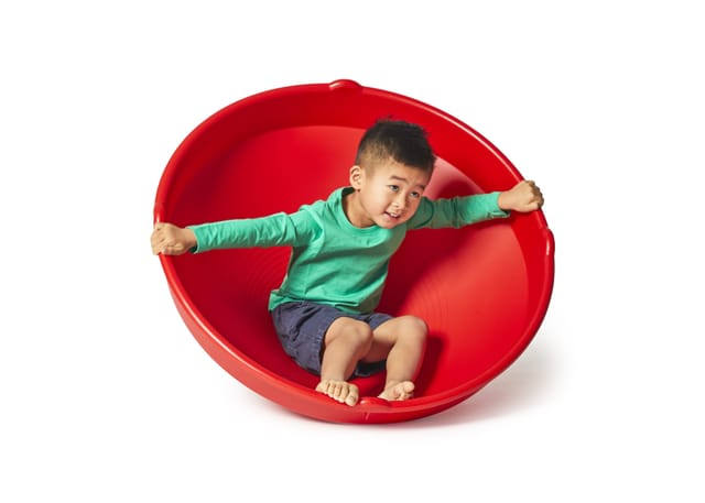 A child sitting in the red Top