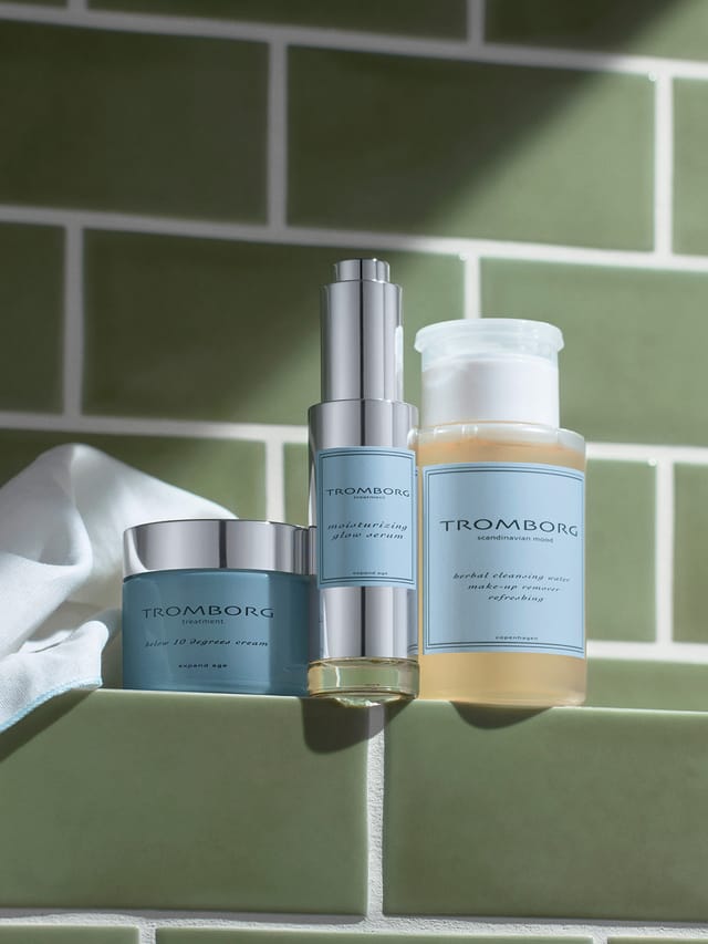 The blue jar of Below 10 Degrees Cream beside a serum and a cleansing water