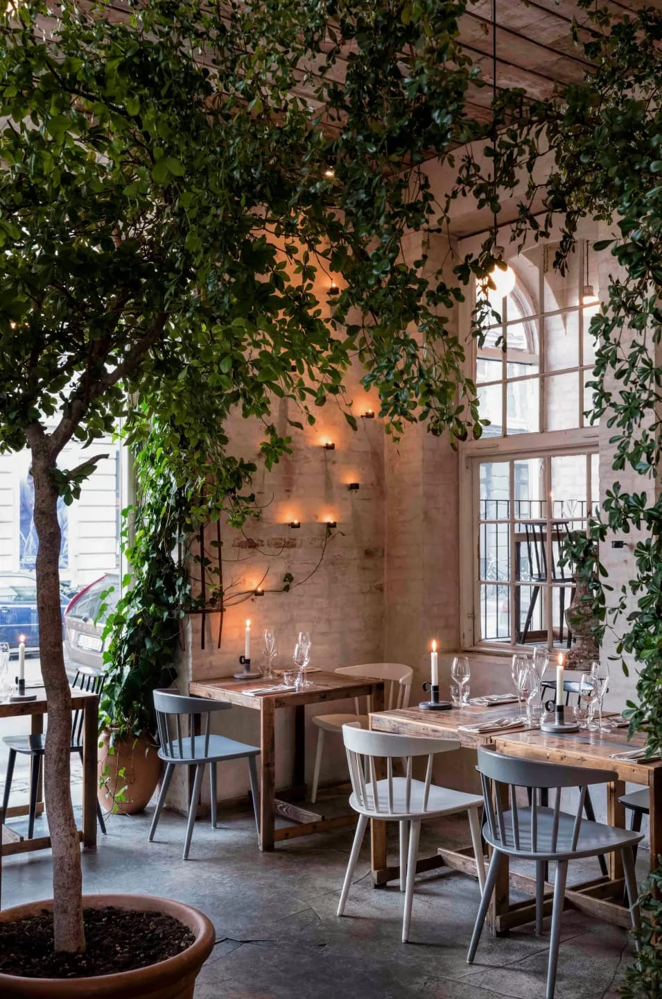The dining room with trees, brick walls and candles