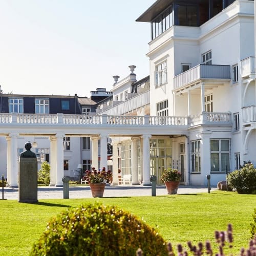 The white main building and colonnade from the lawn