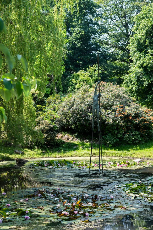 Nicolas Lavarenne's bronze ferryman in a lily pond