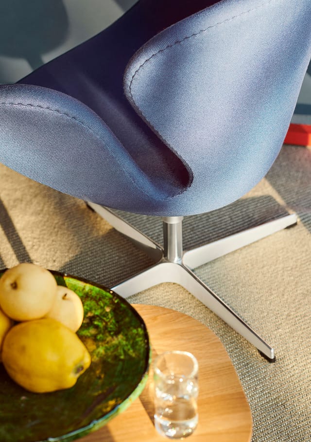 A blue Swan chair and its aluminium base, seen from above