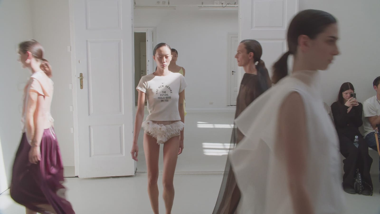 Models in the label's womenswear at a presentation