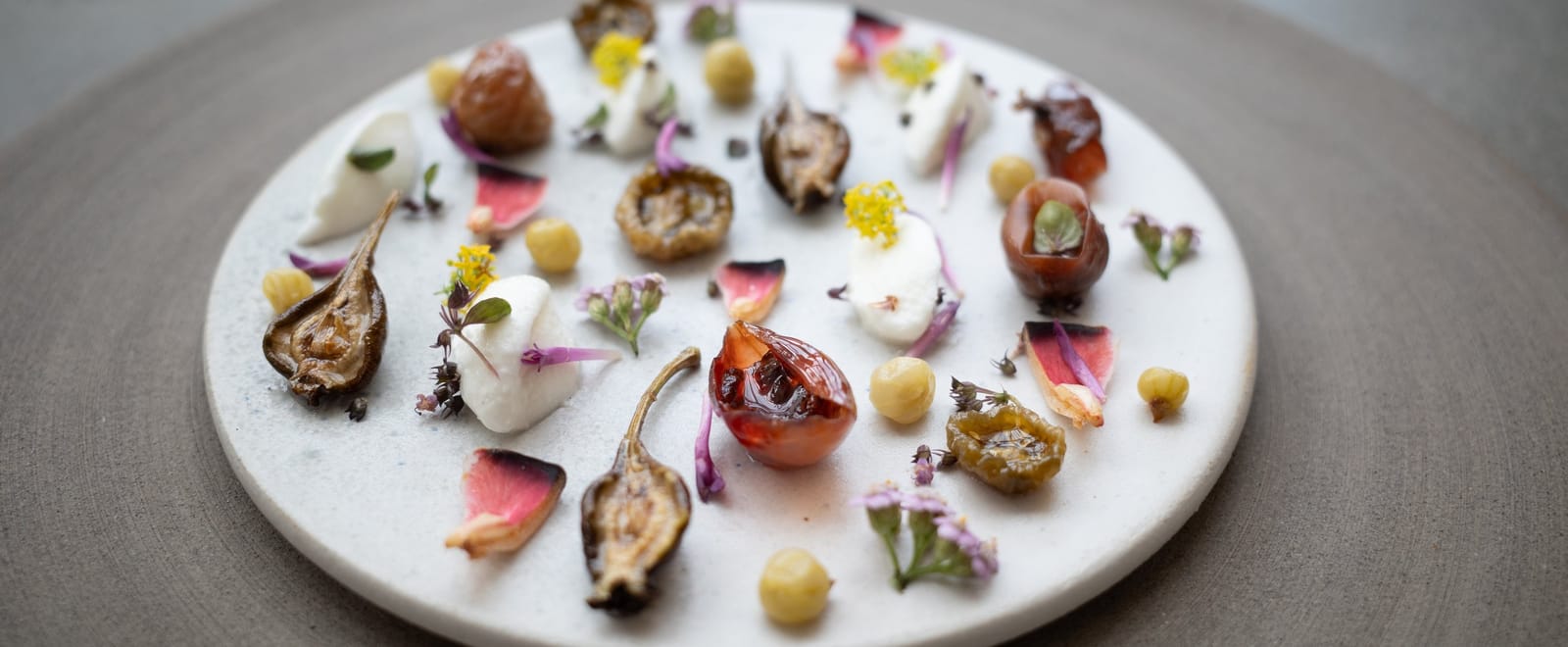 A plate of figs, flowers and cream