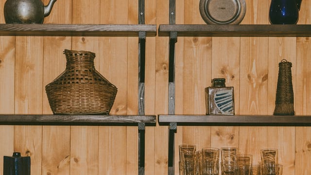 Shelves of pots and glasses on the pine wall