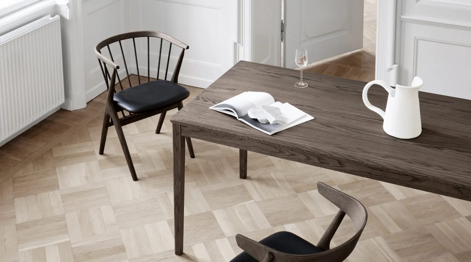 Sibast dining chairs and table in a panelled room