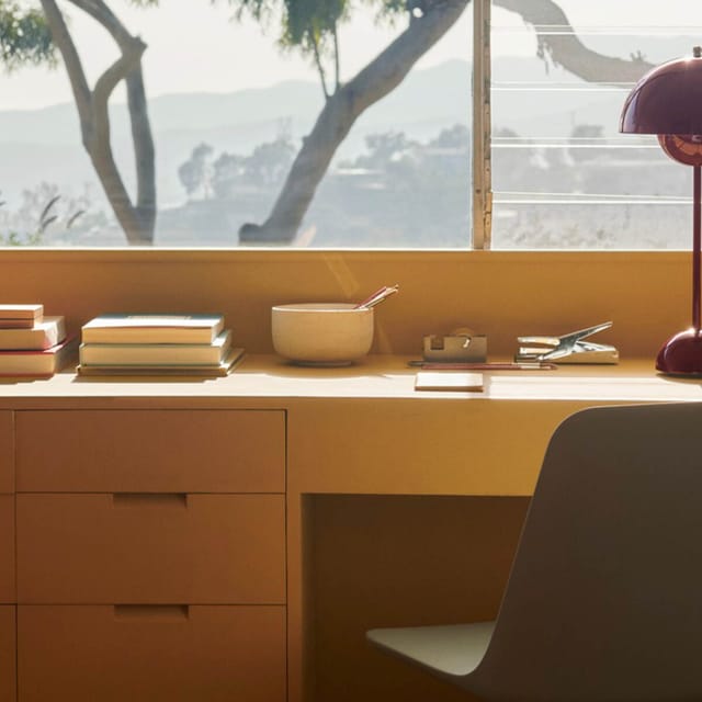 Flowerpot lamp on a desk by a window