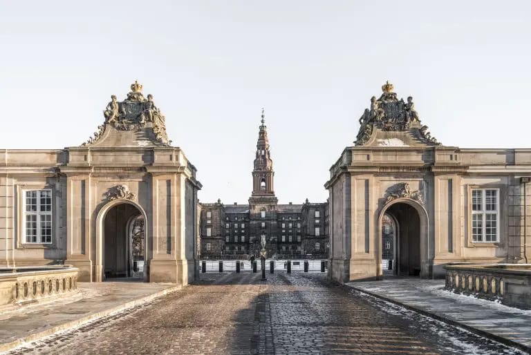 Christiansborg and its tower seen through the gates of the riding ground