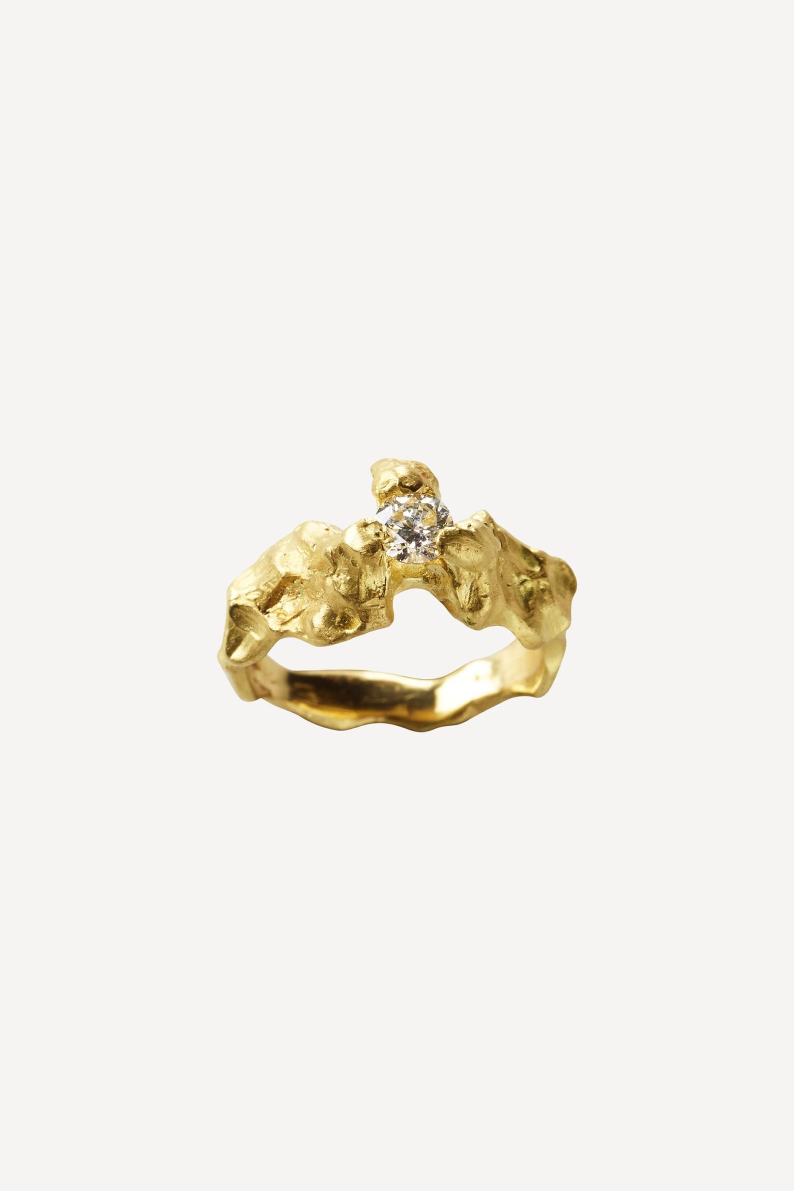 A Rock ring in burned gold with a diamond