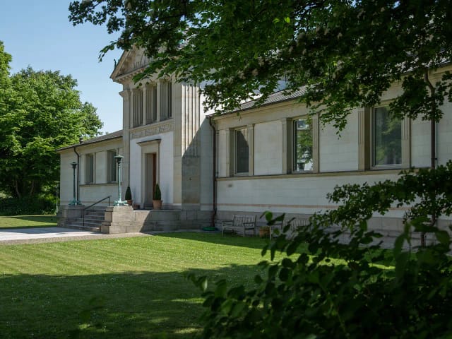The neoclassical facade and entrance from the park