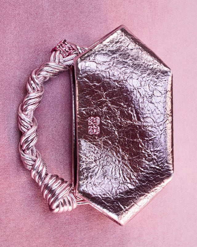 A metallic Bou Bag with a braided handle