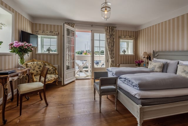 A room with a balcony over the harbour