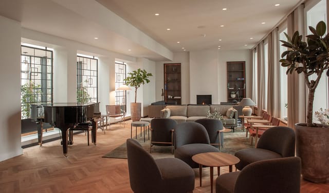 The lobby with its grand piano and fireplace