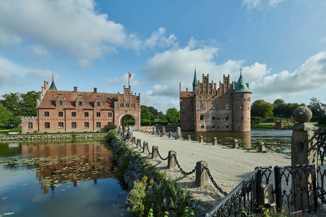 Egeskov across its lake, with the causeway to the gate