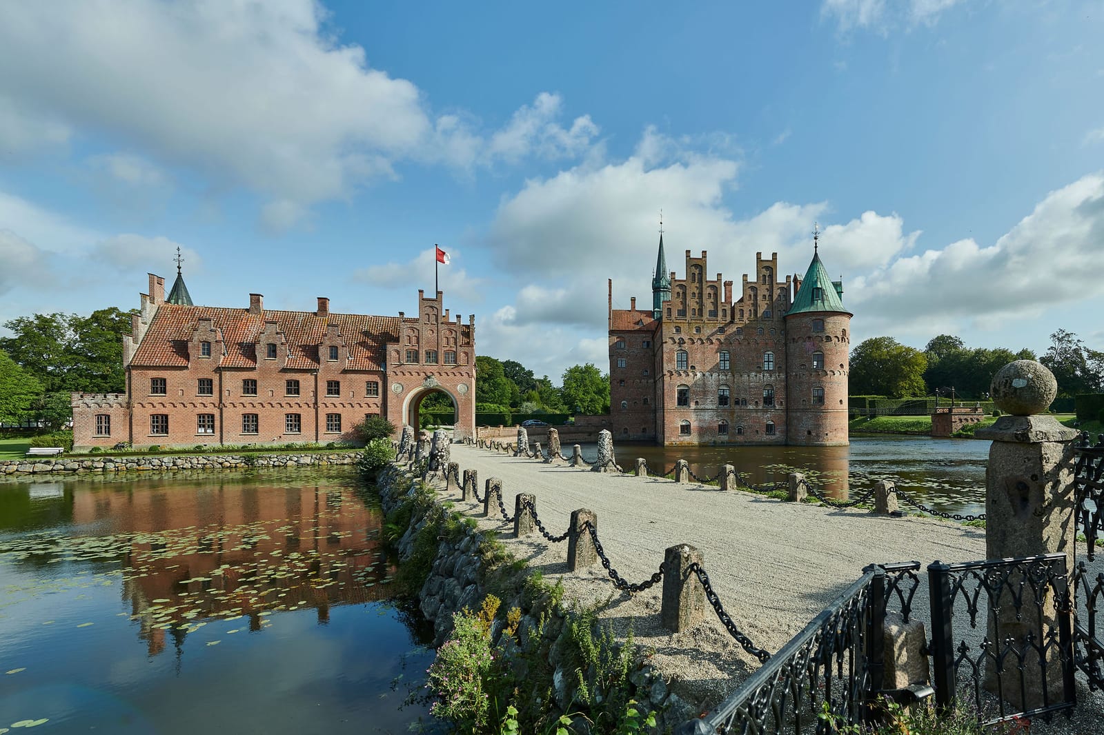 Egeskov across its lake, with the causeway to the gate