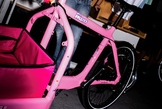 The pink frame with its arcade decals and cargo bag