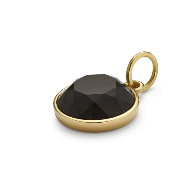 A gold pendant set with faceted mpingo