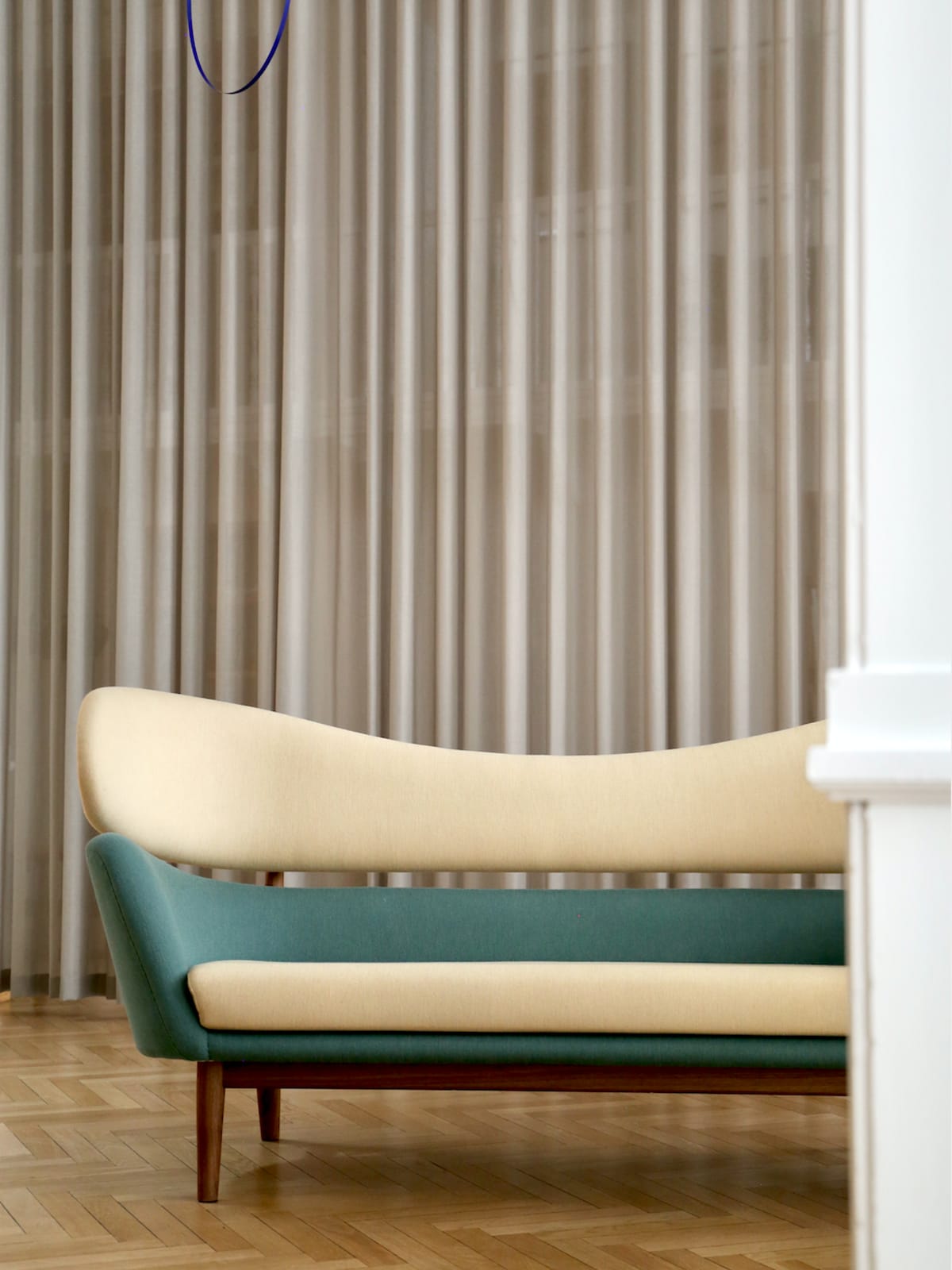 The Baker Sofa with a walnut frame