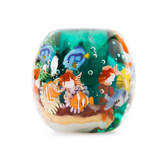 A glass bead with fish and coral