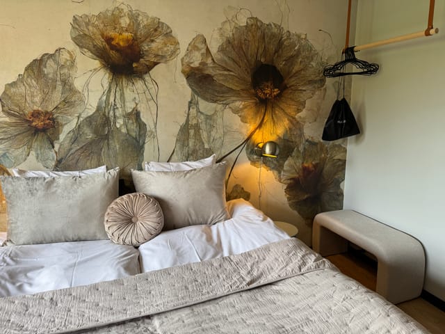 A double room with a flower mural