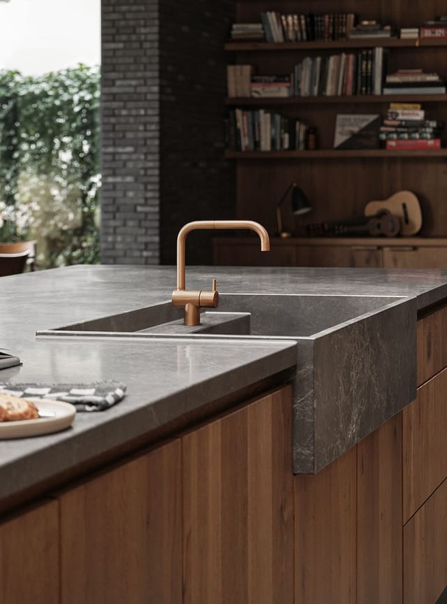 KV1 kitchen mixer in copper at a stone sink